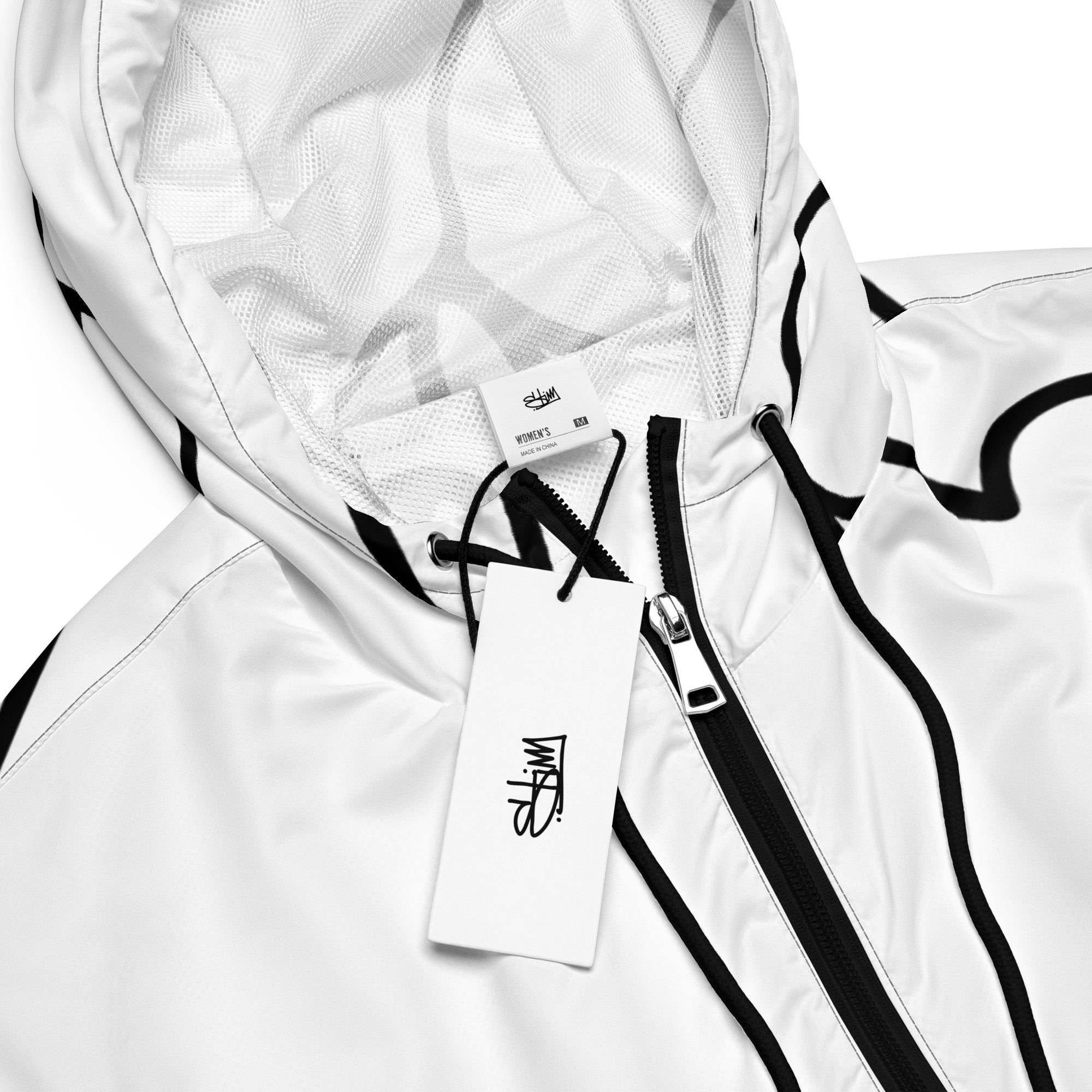 Closeup view of the Stimsons “Bart” line art cropped windbreaker for women, showing neck tag branding and Stimuleye branded clothes tags